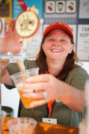 A woman serves a beer at Beau's Oktoberfest