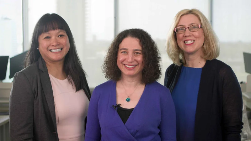 Three women pose for a portrait